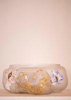 A wide, short, floral enameled glass vase. 