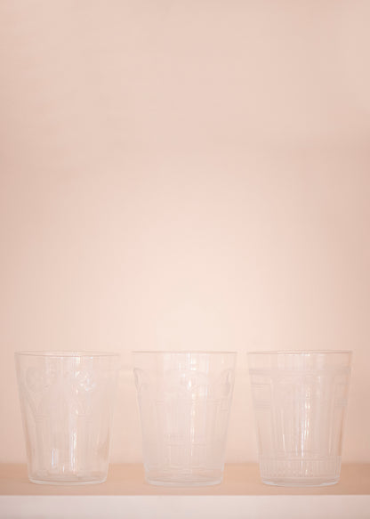 Three crystal cups in front of pale pink background