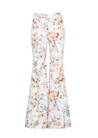 A flat lay of white floral flare pants. 