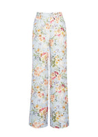 A flat lay of pale blue floral trousers. 