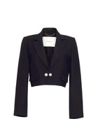 A flat lay image of a cropped black blazer with a pearl button closure. 