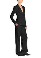 A side view image of a model wearing a black suit. 