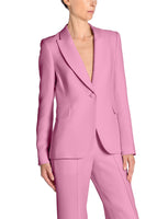 A side angle image of a model wearing a pink blazer and pants.