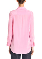 A back angle of a model wearing a pink tie neck top.