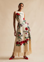 A campaign image of a model wearing a red, floral, embroidered, midi dress. 