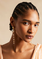A model wearing a pearl drop string earrings.