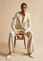 A campaign image of a model wearing in ivory suit. 