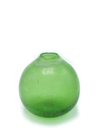 A ghost image of a weathered green glass vase. 