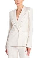 An image of a model wearing an ivory, double breasted blazer. 