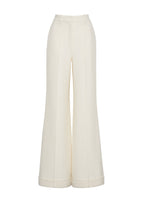 A flat lay of ivory silk wool pants. 