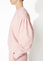 A detailed view of a blush sweatshirt.