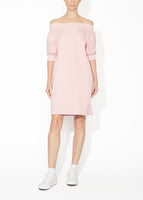 A front view of a blush off the shoulder dress.