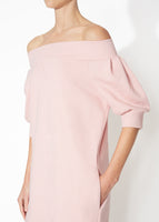 A detailed view of a blush off the shoulder dress.