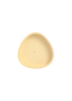 A top view of a cream colored candle. 