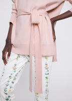 A close-up of the tie on a belted turtleneck sweater.