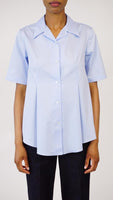 A front view of a button down pale blue shirt.