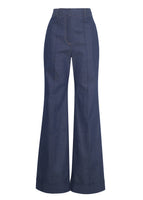 A flat-lay of a pair of indigo denim jeans with a cuffed hem.