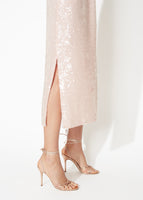 A detail image of a leg slit on a blush pink cami dress.
